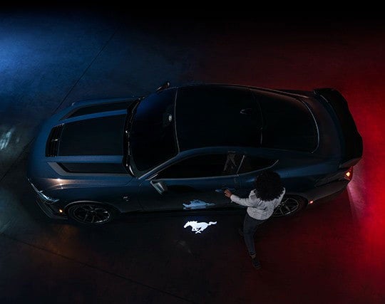 2024 Ford Mustang® Dark Horse™ model with a driver approaching the vehicle | Herb Green Ford, Inc. in Cascade IA