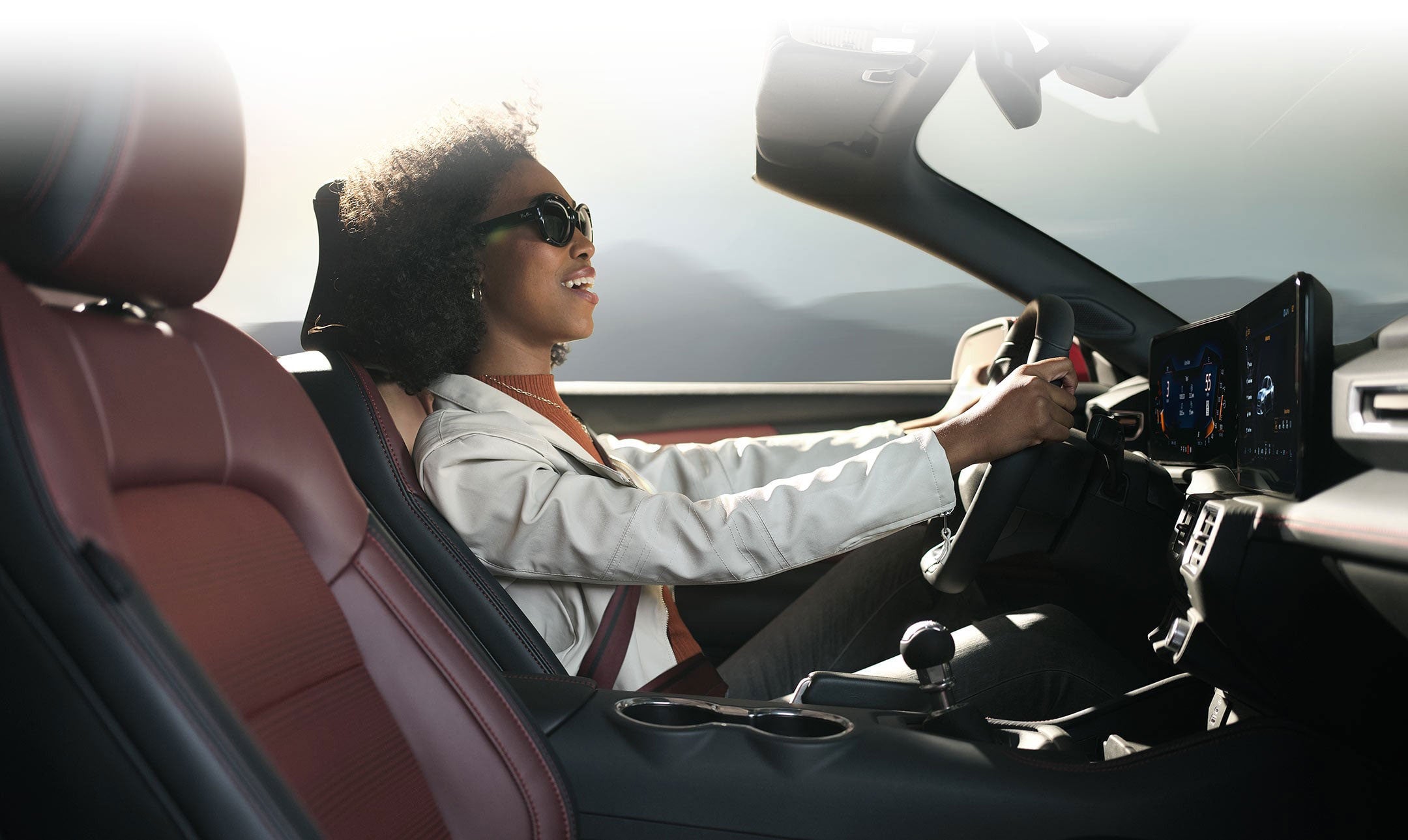 Person sitting in the driver’s seat of a 2024 Ford Mustang® convertible | Herb Green Ford, Inc. in Cascade IA