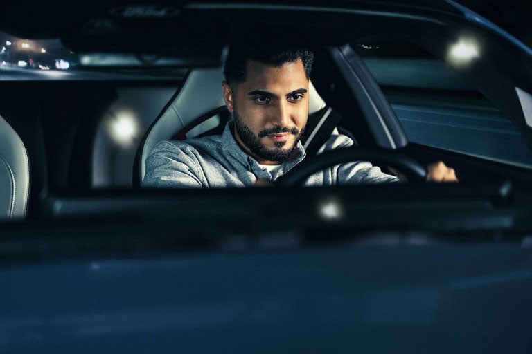 Person sitting in the driver’s seat of a parked 2024 Ford Mustang® coupe | Herb Green Ford, Inc. in Cascade IA